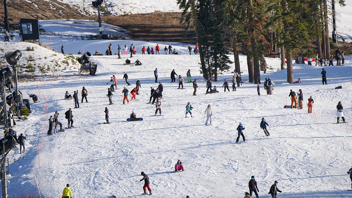People are seen skiing and snowboarding on a mountain near Lake Tahoe in North California.