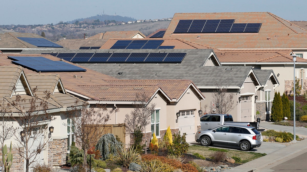 This photo taken Wednesday, Feb. 12, 2020, shows solar panels on rooftops of a housing development in Folsom, California.
