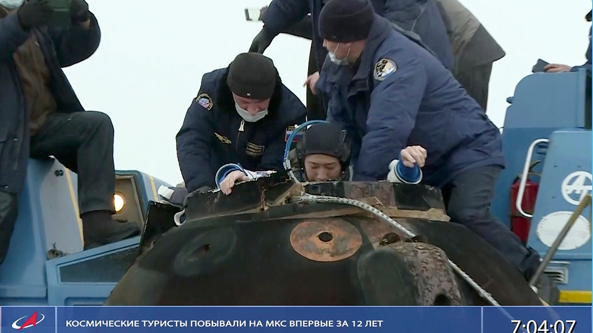Russian space agency rescue team helps Yusaku Maezawa shortly after the landing of the Russian Soyuz MS-20 space capsule in Kazakhstan, Monday, Dec. 20, 2021. 