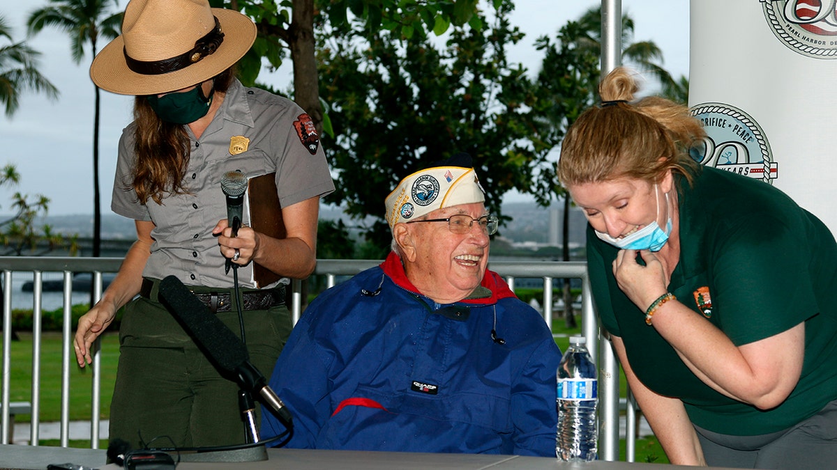 Herb Elfring speaks with National Park Service workers in Pearl Harbor, Hawaii, on Sunday, Dec. 5, 2021. 
