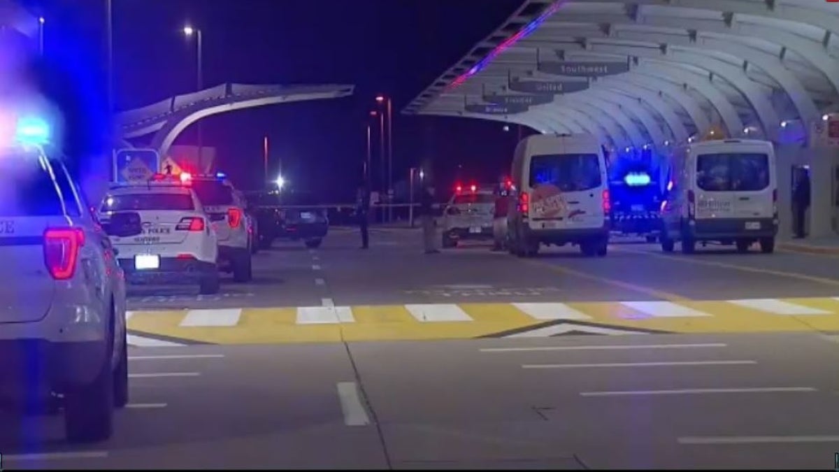 An Oklahoma man confronted his wife in a parking garage after her flight arrived at Tulsa International Airport late Tuesday and attempted to shoot her before trading fire with airport police, authorities said.