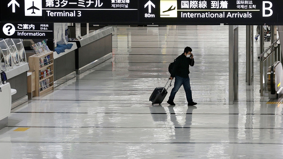 An international arrivals lobby is deserted at Narita International Airport in Narita, east of Tokyo, Japan, Monday, Nov. 29, 2021.