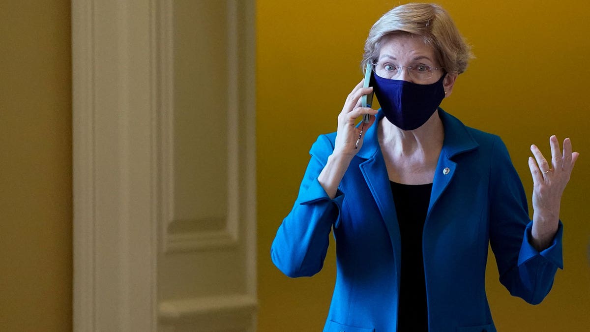 U.S. Senator Elizabeth Warren (D-MA) talks on the phone before the start of the Senate Democrats weekly policy lunch at the U.S. Capitol building in Washington, U.S., December 14, 2021.