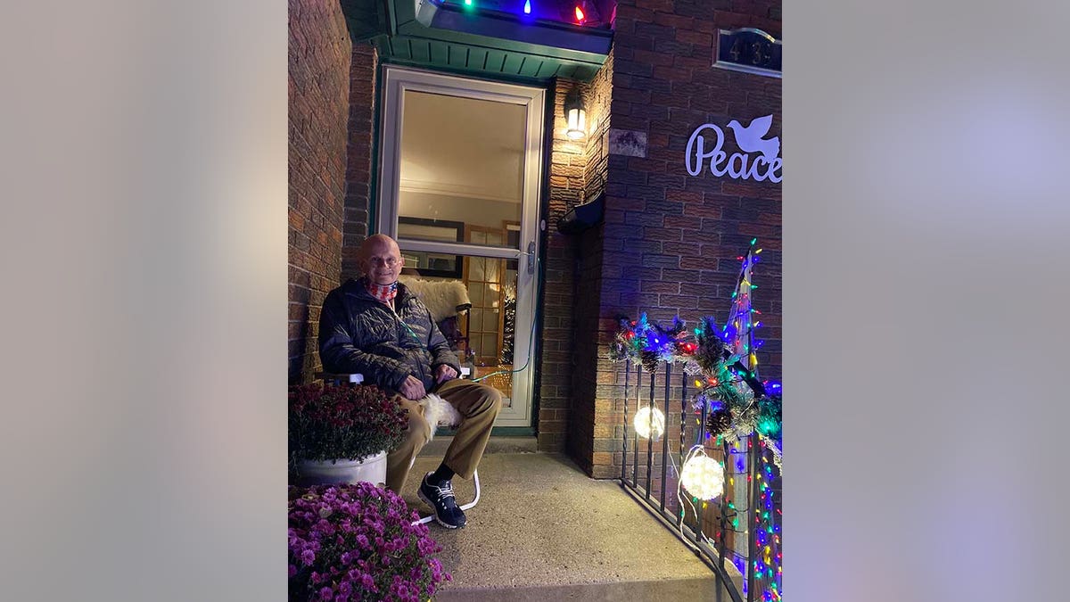 Dale Marks sitting in front of his home in Des Moines, Iowa.
