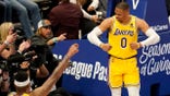 Los Angeles Lakers' Russell Westbrook (0) celebrates after sinking a basket as fans look on in the second half of an NBA basketball game in Dallas, Wednesday, Dec. 15, 2021.