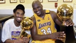 LOS ANGELES, UNITED STATES:  Kobe Bryant (L) of the Los Angeles Lakers holds the Larry O'Brian trophy as teammate Shaquille O'Neal (L) hold the MVP trophy after winning the NBA Championship against Indiana Pacers 19 June, 2000, after game six of the NBA Finals at Staples Center in Los Angeles, CA.
