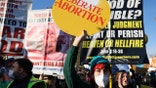 Pro-abortion rights activist Alicia Hurt holds a placard during a protest outside the Supreme Court building, ahead of arguments in the Mississippi abortion rights case Dobbs v. Jackson Women's Health, in Washington, Dec. 1, 2021. REUTERS/Evelyn Hockstein