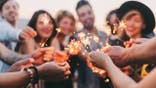 happy friends holding sparklers