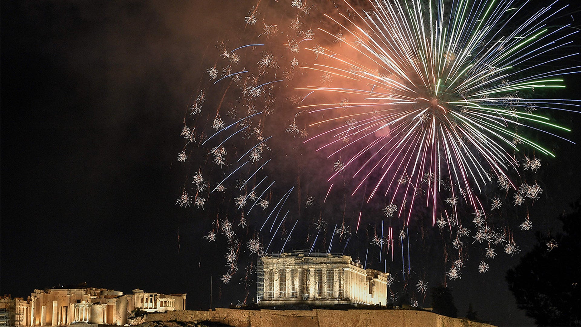 Fireforks explode over the Ancient Acropolis in Athens during the New Year's Eve celebrations on December 31, 2021.