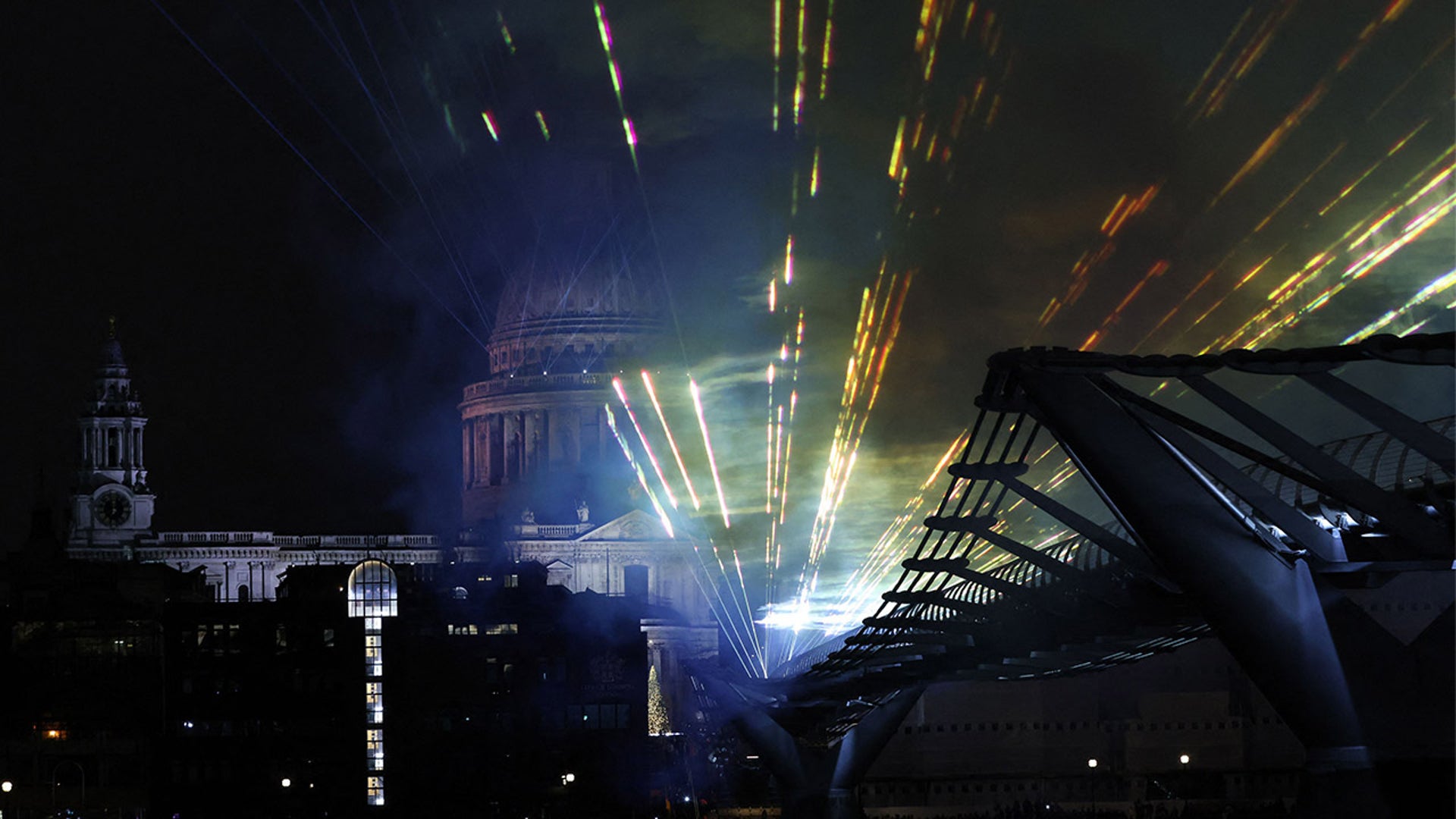 A laser display is pictured above the Millennium Bridge, an alternative to the usual New Year's fireworks display, in central London just after midnight on January 1, 2022.