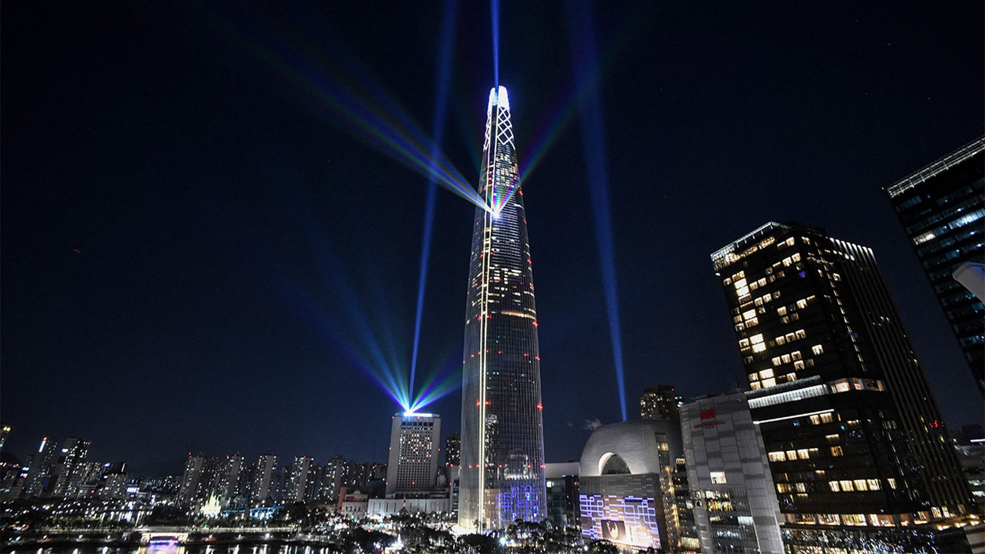 Beam lights are projected from the 123-storey Lotte World Tower skyscraper during a countdown lighting show to celebrate the New Year in Seoul on January 1, 2022.
