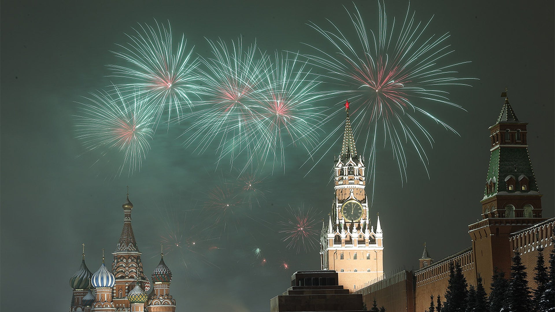 Fireworks lights up the sky over the Moscow Kremlin's Spasskaya Tower and St Basil's Cathedral during New Year celebrations.