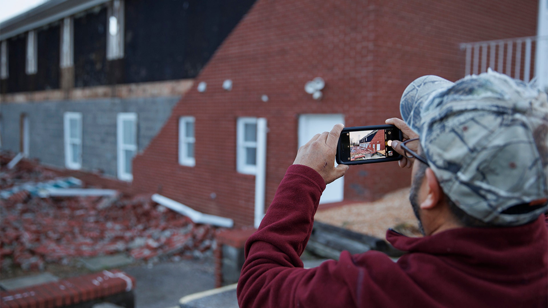 Miguel Macias surveys the damage to Emmanuel Baptist Church where he came for shelter last night during the tornado on December 11, 2021 in Mayfield, Kentucky. 