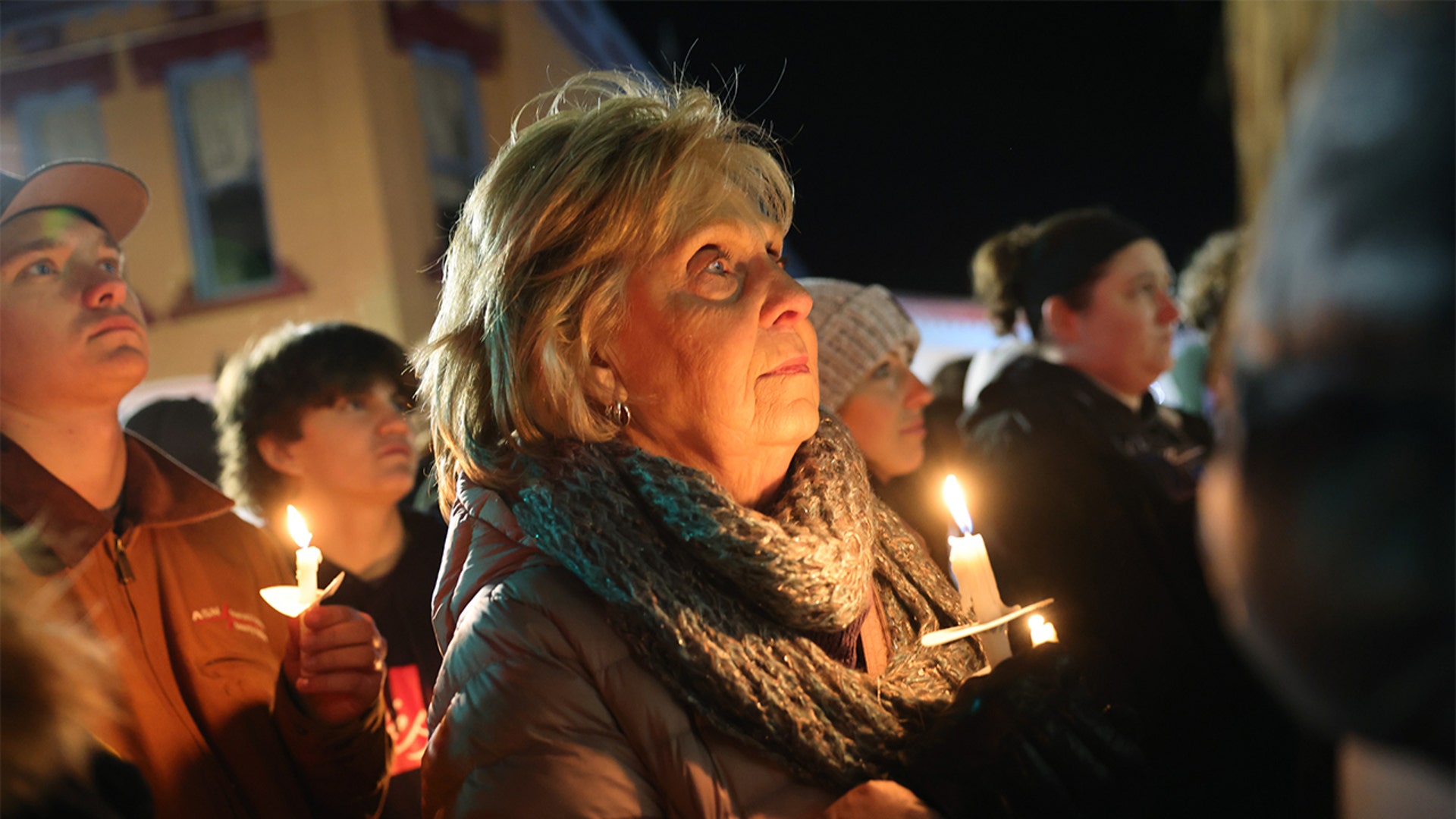 People attend a vigil downtown to honor those killed and wounded during the recent shooting at Oxford High School on December 03, 2021 in Oxford, Michigan. Four students were killed and seven others injured on November 30, when student Ethan Crumbley allegedly opened fire with a pistol at the school. Crumbley has been charged in the shooting. Today his parents were also charged.