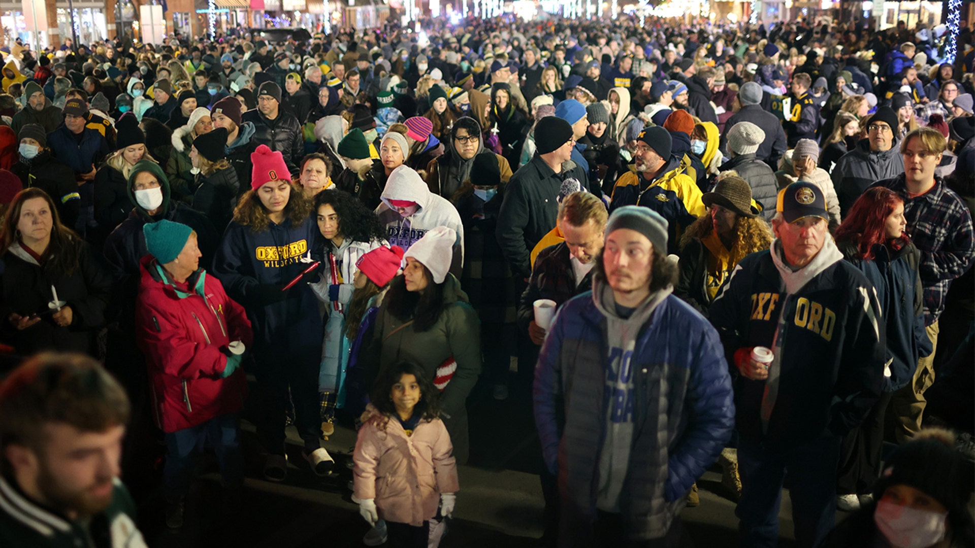People attend a vigil downtown to honor those killed and wounded during the recent shooting at Oxford High School on December 03, 2021 in Oxford, Michigan. Four students were killed and seven others injured on November 30, when student Ethan Crumbley allegedly opened fire with a pistol at the school. Crumbley has been charged in the shooting. Today his parents were also charged.