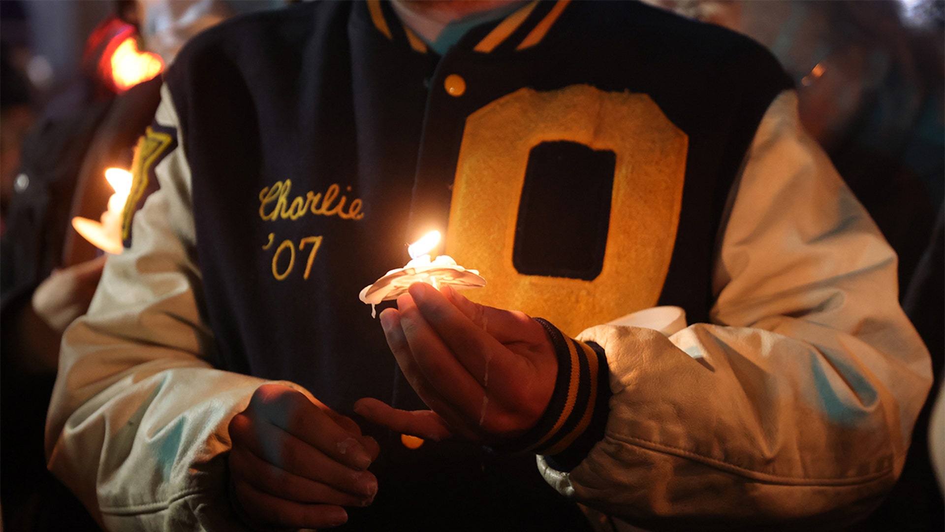 People attend a vigil downtown to honor those killed and wounded during the recent shooting at Oxford High School on December 03, 2021 in Oxford, Michigan. Four students were killed and seven others injured on November 30, when student Ethan Crumbley allegedly opened fire with a pistol at the school. Crumbley has been charged in the shooting. Today his parents were also charged.