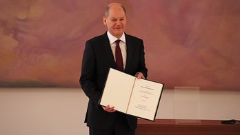 Scholz succeeds Merkel as German chancellor, opening new era