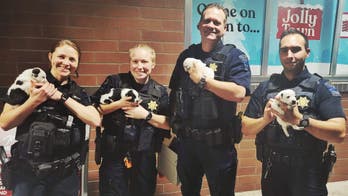 Tulsa cops rescue, adopt 'abandoned Christmas puppies' found zipped up in duffel bag