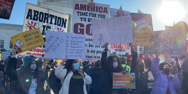 Pro and anti-abortion activists gather outside the Supreme Court.