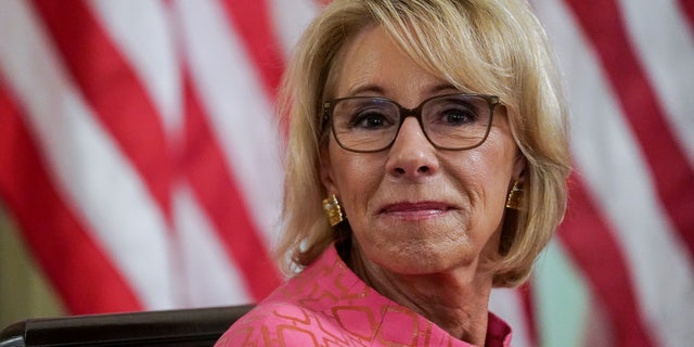 U.S. Education Secretary Betsy Devos listens during a coronavirus disease (COVID-19) pandemic response event about reopening schools hosted by U.S. President Donald Trump in the State Dining Room at the White House in Washington, U.S., August 12, 2020. REUTERS/Kevin Lamarque