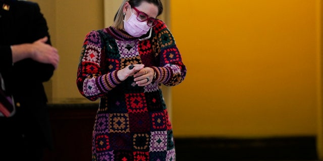 U.S. Senator Kyrsten Sinema (D-AZ) talks on her phone outside a Democratic policy luncheon at the U.S. Capitol in Washington, U.S., Dec. 16, 2021.