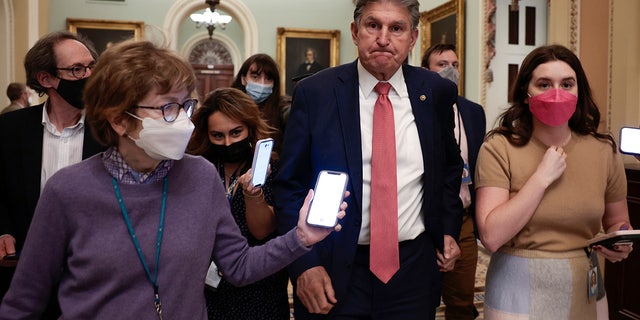 Sen. Joe Manchin, D-W.Va., is followed by reporters as he leaves a caucus meeting with Senate Democrats at the U.S. Capitol Building on Dec. 17, 2021, in Washington. 