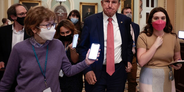 Sen. Joe Manchin, D-W.Va., is followed by reporters as he leaves a caucus meeting with Senate Democrats at the U.S. Capitol Building on Dec. 17, 2021, in Washington. 