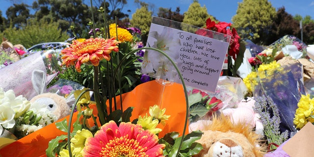 Flowers and tributes are seen outside Hillcrest Primary School in Devonport, Tasmania, Australia December 17, 2021. Australian police on Friday said investigations were continuing into the deaths of five children after a jumping castle was lifted into the air from strong winds at the school's end-of-year celebration, including if it was properly tied to the ground. AAP Image/Ethan James via REUTERS  ATTENTION EDITORS - THIS IMAGE WAS PROVIDED BY A THIRD PARTY. NO RESALES. NO ARCHIVE. AUSTRALIA OUT. NEW ZEALAND OUT