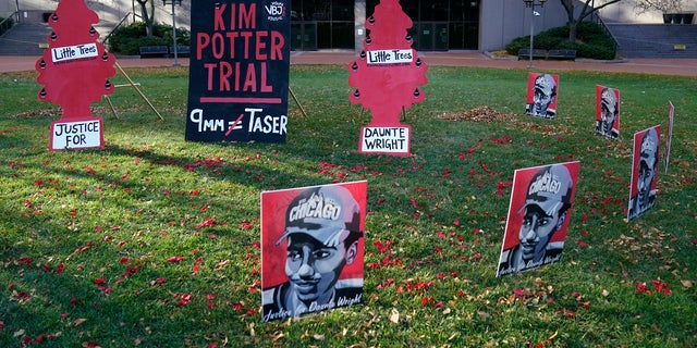 Posters stand on the south lawn Tuesday, Nov. 30, 2021, at the Hennepin County Government Center in Minneapolis where jury selection begins for former suburban Minneapolis police officer Kim Potter, who says she meant to grab her Taser instead of her handgun when she shot and killed motorist Daunte Wright. (AP Photo/Jim Mone)