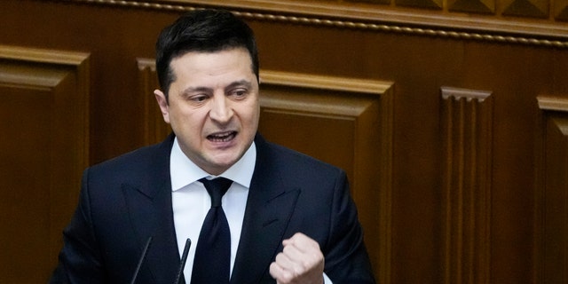 Ukrainian President Volodymyr Zelenskyy gestures as he addresses lawmakers in Kyiv, Ukraine, Wednesday, Dec. 1, 2021. 