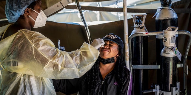 A woman is tested for COVID-19 at the Lenasia South Hospital, near Johannesburg, South Africa, Wednesday, Dec. 1, 1021.Â