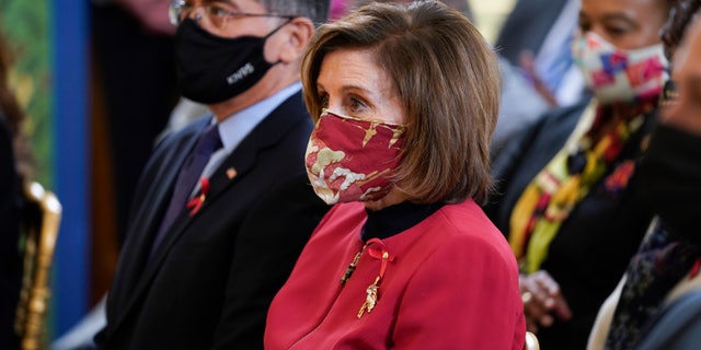 House Speaker Nancy Pelosi of Calif., and Health and Human Services Secretary Xavier Becerra listen before President Joe Biden at an event to commemorate World AIDS Day in the East Room of the White House, Wednesday, Dec. 1, 2021, in Washington. (AP Photo/Evan Vucci)