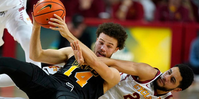 Iowa State guard Tristan Enaruna (23) tries to steal the ball from Arkansas-Pine Bluff guard Brahm Harris (14) during the first half of an NCAA college basketball game, miércoles, dic. 1, 2021, in Ames, Iowa.