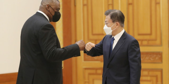 South Korean President Moon Jae-in, right, bumps elbows with U.S. Defense Secretary Lloyd Austin before their meeting at the presidential Blue House in Seoul, South Korea, Thursday, Dec. 2, 2021. (Ahn Jung-hwan/Yonhap via AP)