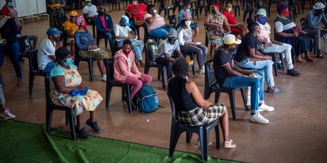 People who have just received their jab against COVID-19 Friday Dec. 3, 2021 wait for their vaccine card to be processed at the Orange Farm, South Africa, multipurpose center. South Africa has accelerated its vaccination campaign a week after the discovery of the omicron variant of the coronavirus. (AP Photo/Jerome Delay)