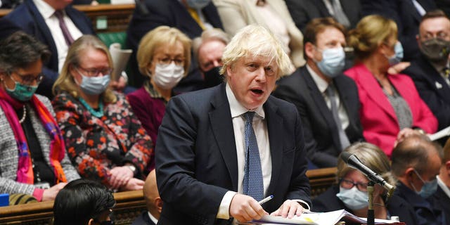 In this photo posted by the UK Parliament, British Prime Minister Boris Johnson speaks during the Prime Minister's questions in the House of Commons, London, Wednesday, December 8, 2021. (Jessica Taylor / UK Parliament via AP)