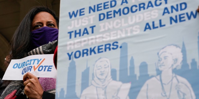 Activists participate in a rally on the steps of City Hall ahead of a City Council vote to allow lawful permanent residents to cast votes in elections to pick the mayor, City Council members and other municipal officeholders, Donderdag, Des. 9, 2021, In New York.