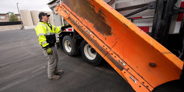 Chris Vigil prepares his snowplow for operation as forecasters predict the first snow of the season to sweep over Front Range communities Thursday, Dec. 9, 2021, at the Colorado Department of Transportation shed in Castle Rock, Colo. States are the latest victims of the nationwide labor shortage since trying to find snowplow drivers has increasingly become difficult as the winter months bear down on northern climes. (AP Photo/David Zalubowski)