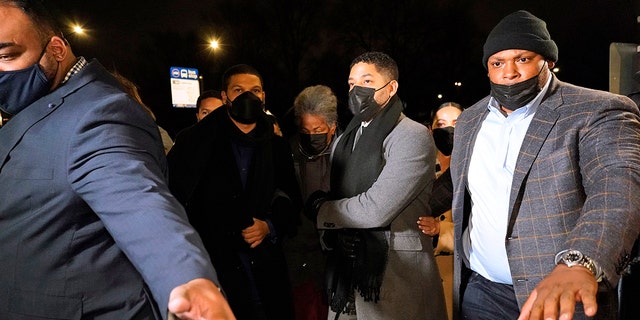 Actor Jussie Smollett, second from right, along with his mother Janet, returns to the Leighton Criminal Courthouse, Thursday, Dec. 9, 2021, in Chicago, after the jury reached a verdict in his trial. 