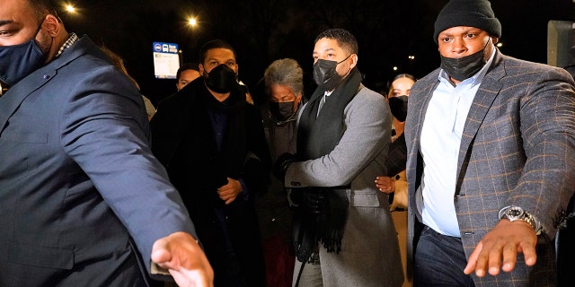 Actor Jussie Smollett, second from right, along with his mother Janet, returns to the Leighton Criminal Courthouse, Thursday, Dec. 9, 2021, in Chicago, after the jury reached a verdict in his trial. 