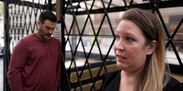 Caitlin Foster stands outside the Noir Lounge she manages in Hayes Valley and talks about the declining quality of life in San Francisco, Thursday, Dec. 2, 2021. (AP Photo/Eric Risberg)