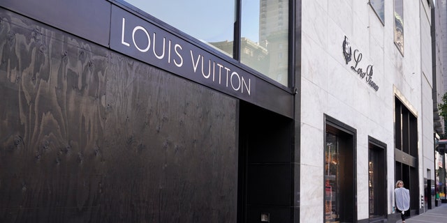 A large window of the Louis Vuitton store is seen boarded up following a recent robbery at Union Square in San Francisco. (AP Photo/Eric Risberg)