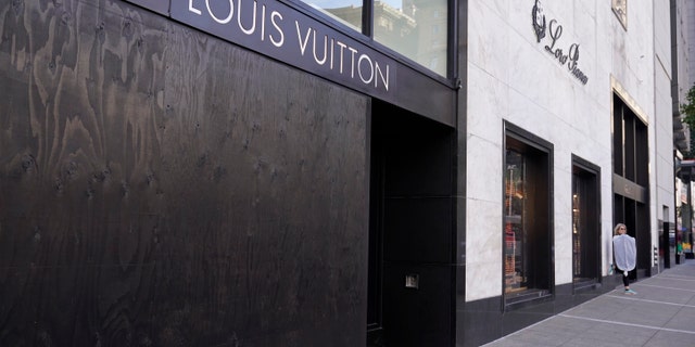 A large window of the Louis Vuitton store is seen boarded up following a recent robbery at Union Square in San Francisco. (AP Photo/Eric Risberg)