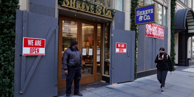 A security guard stands outside the heavily boarded Shreve &amp;amp; Co. jewelry store in San Francisco, Thursday, Dec. 2, 2021. (AP Photo/Eric Risberg)