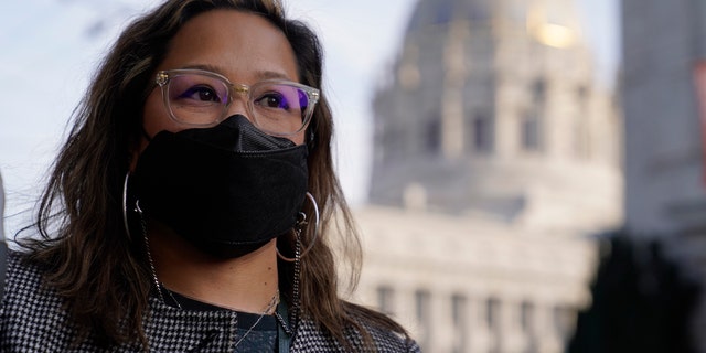 Administrative assistant LeAnn Corpus stands near City Hall in San Francisco, Thursday, Dec. 2, 2021. (AP Photo/Eric Risberg)