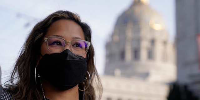 Administrative assistant LeAnn Corpus stands near City Hall in San Francisco, Thursday, Dec. 2, 2021. (AP Photo/Eric Risberg)