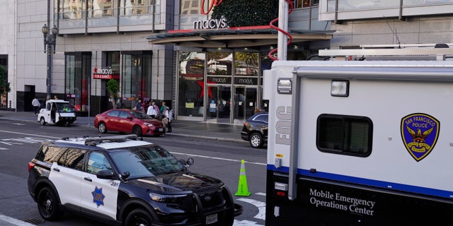 Police vehicles are stationed at Union Square following recent robberies in San Francisco. (AP Photo/Eric Risberg)