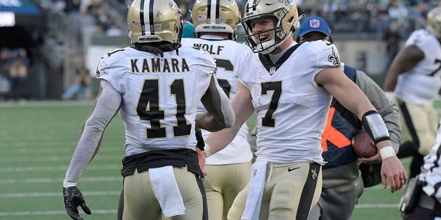 New Orleans Saints quarterback Taysom Hill, right, celebrates with Alvin Kamara (41) after Kamara scored a touchdown during the first half of an NFL football game against the New York Jets, Sunday, December 12, 2021 in East Rutherford, NJ
