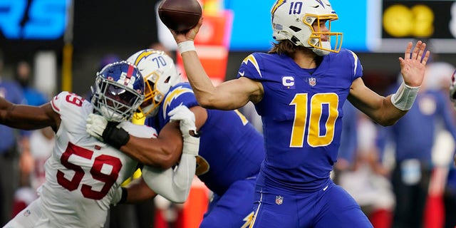 Los Angeles Chargers quarterback Justin Herbert throws against the New York Giants during the first half of an NFL football game Sunday, Dec. 12, 2021, in Inglewood, Calif.