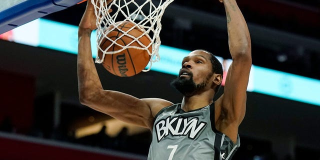 Brooklyn Nets forward Kevin Durant dunks during the second half of a game against the Detroit Pistons Dec. 12, 2021, in Detroit.